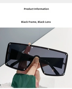 Detail of oversized square sunglasses featuring silver rivets around dark grey lenses