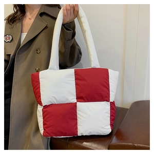 Close-up of a large quilted down tote bag with a stylish red and white checkerboard pattern