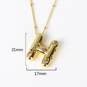 Detail view of gold letter H pendant with clear cubic zirconia inlay and dimensions