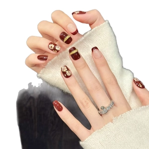 Burgundy and white cat eye press-on nails with vintage gold flower and metallic detail