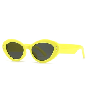 Baroque style cat-eye sunglasses with yellow frames and black lenses featuring star rivets