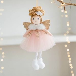 Pink tulle Christmas angel ornament with gold wings hanging on festive tree branches