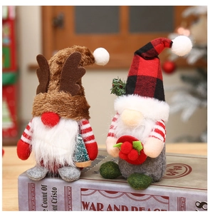 Detail of Christmas gnomes with plaid hats and antlers sitting on decorative books