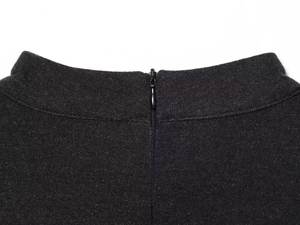 Macro shot of a high-quality invisible zipper on a slim fit black textured dress