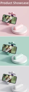 Three-in-one folding portable fan with phone stand in pink, green, and white colors