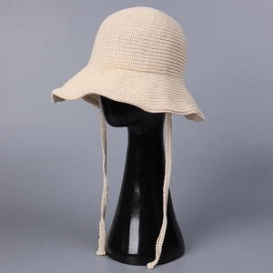 Lightweight breathable crochet bucket hat in beige with decorative bow tie strings