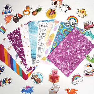 Flat lay of colorful DIY journal stickers and decorative background papers for kids