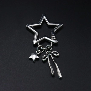 Close-up of stainless steel star-shaped lobster clasp with butterfly and star charms