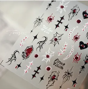 Dettaglio macro di adesivi unghie gotici con occhi rossi, ragnatele e texture 3D a rilievo