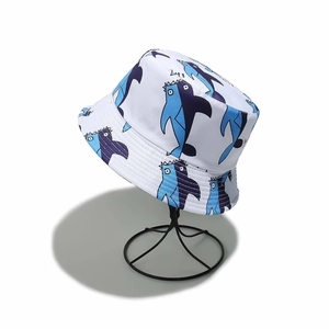 Detail of white bucket hat with cartoon shark print on a black metal display stand