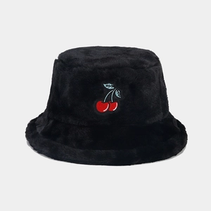 Detail of plush black bucket hat featuring a cute red cherry embroidery texture