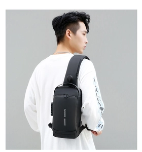 Detail of minimalist black sling bag featuring an anti-theft combination lock and matte finish