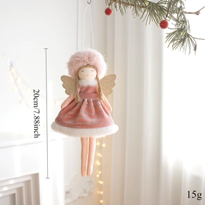 Detail of pink plush Christmas angel pendant with gold wings hanging on pine branch