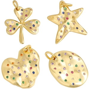 Golden clover starfish heart and oval charms with colorful zircon stones on white background
