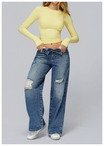 Detailed look at yellow long sleeve yoga top with distressed wide-leg ripped jeans