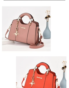 Detail of pink and orange leather handbags with metal hardware and geometric charms