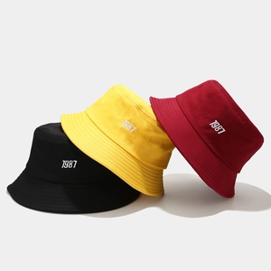Fashionable 1987 embroidered cotton bucket hats shown in black, yellow and red colors