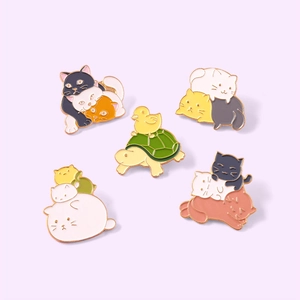Set of five cute enamel pins featuring colorful stacked cats and a duck riding a turtle