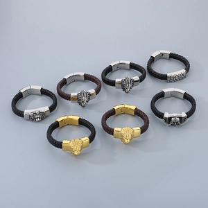 Top view of eight men's braided leather bracelets with lion and skull metal charms
