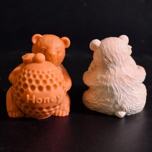 Detailed relief texture on honey bear silicone candle molds showing front and back views