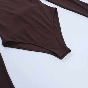 Detail of dark brown bodysuit showing high-stretch fabric and snap closure at the bottom
