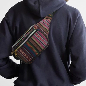 Detailed view of bohemian crossbody bag with ethnic woven patterns and gold zipper