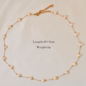 Detail view of gold pearl necklace on silk background with length and weight specs