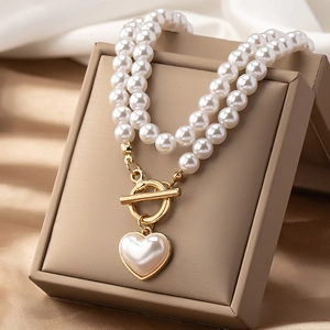 French vintage double-layered pearl necklace with golden OT clasp and heart pendant
