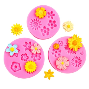 Pink silicone flower mold set for fondant daisies and roses on white background