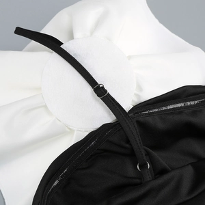 Detail of adjustable straps and non-slip silicone strip on black and white dress