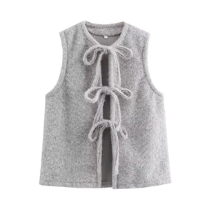 Detail of grey fuzzy mohair vest featuring round neck and front lace-up tie closures