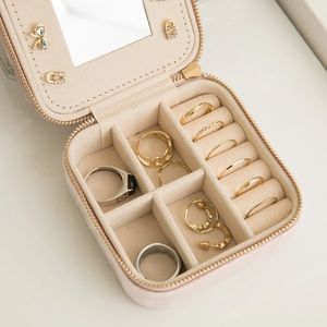 Pink velvet portable jewelry travel case with mirror and zipper closure for rings