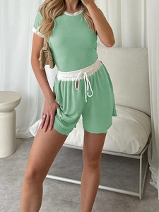 Detail of green ribbed short sleeve top and matching shorts with white drawstring waist