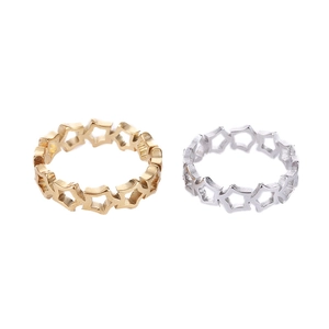 Detailed view of hollow star-patterned rings in gold and silver stainless steel finish