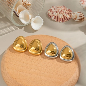 Chic gold and silver stainless steel earrings displayed on a natural wooden tray with shells