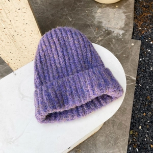 Close-up of purple chunky knit beanie showing thick ribbing and soft fuzzy wool texture