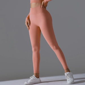 Close-up of coral orange seamless yoga set with high waist leggings and thumb hole sleeves