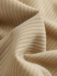 Macro shot of khaki waffle knit fabric texture showing high-density fiber details