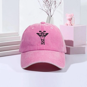 Close-up of giraffe embroidery on pink washed cotton baseball cap with decor
