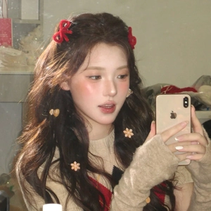Close-up of a festive red velvet bow hairpin with snowflake and gingerbread man hair clips