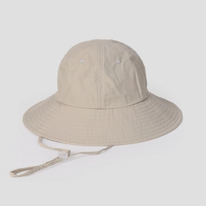 Detail of breathable outdoor sun hat fabric featuring ventilation eyelet and adjustable cord