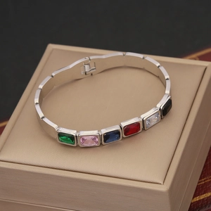 Silver stainless steel bracelet with multi-colored rectangular gemstones in macro view