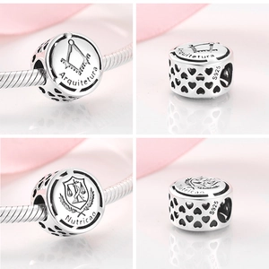 Detailed views of S925 silver Arquitetura and Nutricao charms with heart cut-outs