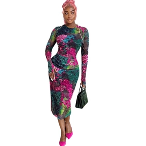 Elegant slim-fit long-sleeve maxi dress with vibrant floral print and round neck