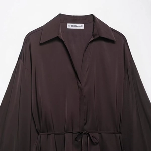 Dark brown satin shirt dress with long sleeves and a matching tie-waist belt on a hanger