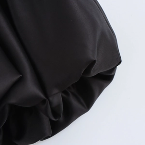 Chic black bubble mini skirt in smooth satin fabric with elegant French style pleats