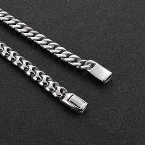 Macro shot of silver 316L stainless steel Cuban chain link with engraved clasp detail