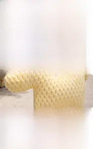 Detailed view of the yellow pony plush pillow featuring soft waffle texture fabric