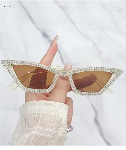Macro detail of luxury cat-eye sunglasses with hand-set rhinestones on a marble background