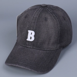 Detail shot of white 3D embroidered B letter on charcoal grey washed denim baseball cap